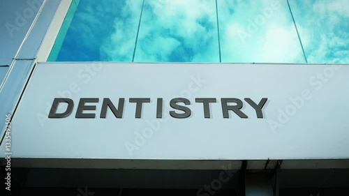 Dentistry sign on a modern building with glass windows, symbolizing dental care, oral health, and medical services