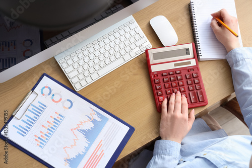 Female accountant with calc...