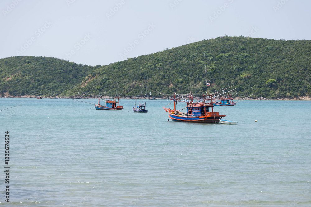 Experience the tranquility of serene waters adorned with vibrant fishing boats and lush green hills, reflecting the beauty of natures coastal landscape in perfect harmony. Experience the tranquility of serene waters adorned with vibrant fishing boats and lush green hills, reflecting the beauty of natures coastal landscape in perfect harmony.