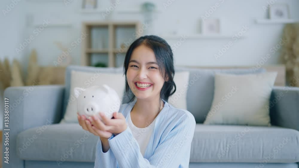 Young Asian woman putting coin in piggy bank. Save money and financial investment