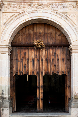 Giant wooden doors at the entrance to a historic cathedral in Oaxaca Mexico