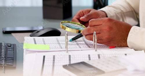 The African auditor is scrutinizing financial documents