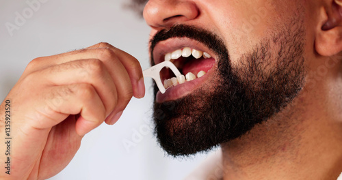 Man Expertly Flosses Teeth, Emphasizing Importance