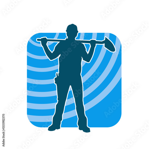 Silhouette of a worker carrying shovel tool. Silhouette of a worker in action pose using shovel tool.