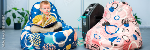 Oxygen therapy, also referred to as supplemental oxygen. Young boy with respiratory problems inhaling oxygen through nasal cannula attached to concentrator machine.