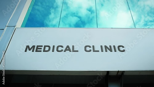 Medical clinic sign on a modern building with clear glass windows, symbolizing healthcare services, professionalism, and wellness