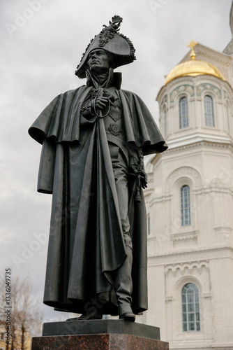 Monument to Admiral Fyodor Ushakov on the background of the Naval Cathedral of St. Nicholas the Wonderworker, Kotlin Island. Russia, Kronstadt, 7.07.2022