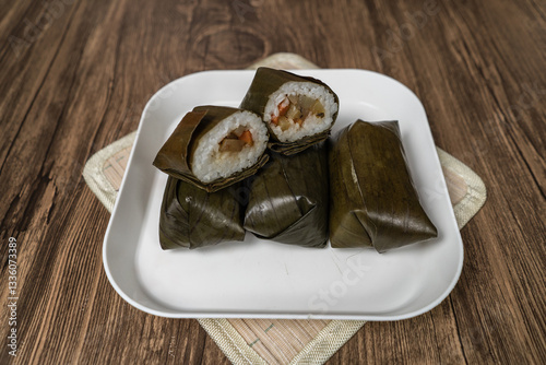 Lontong Isi - Indonesian traditional food, Lontong isi is rice filled with oncom or vegetables and wrapped with banana leaves. Lontong is a popular food during Ramadan 
