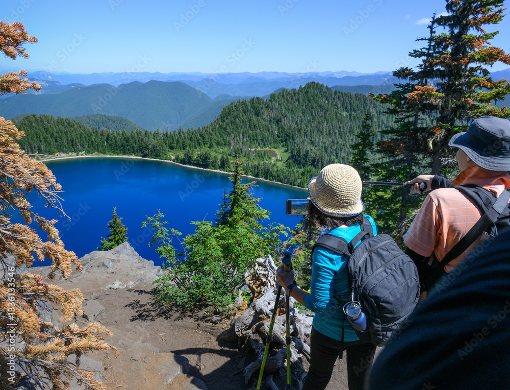 People taking photos of Summit lake using smartphones. Mt Rainier National Park. Washington State.