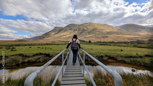 Obraz na płótnie Beautiful woman backpacker in hooded jacket hiking at river Erriff near Aesleagh, county Mayo, Ireland, Irish landscape, mountains and nature background w salonie