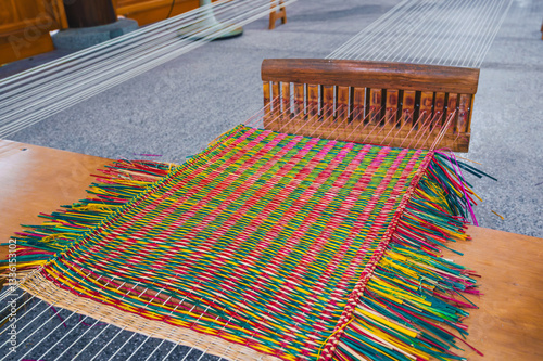 weaving and making a handmade rug. close-up of a loom.