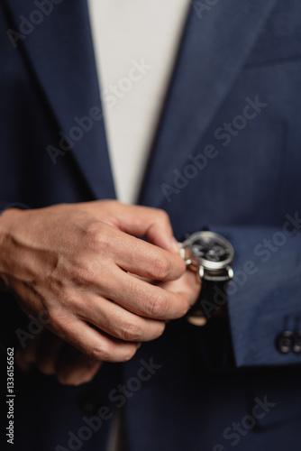 businessman holding a watch