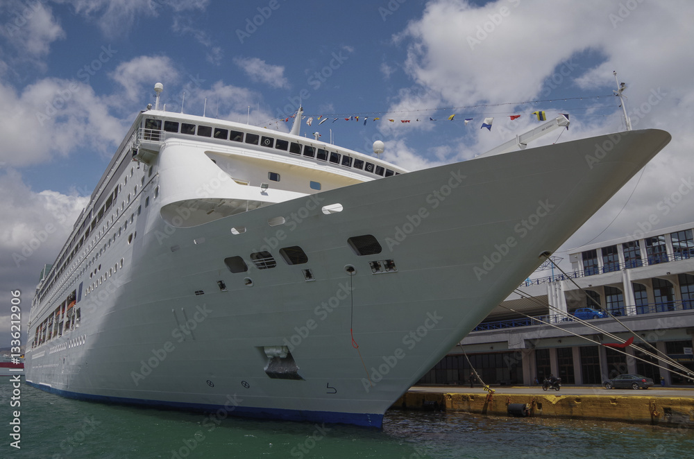 Classic cruiseship or cruise ship liner Neo Riviera in Piraeus Athens, Greece port on sunny day blue sky during Mediterranean Aegean Greek islands summer cruising dream vacation