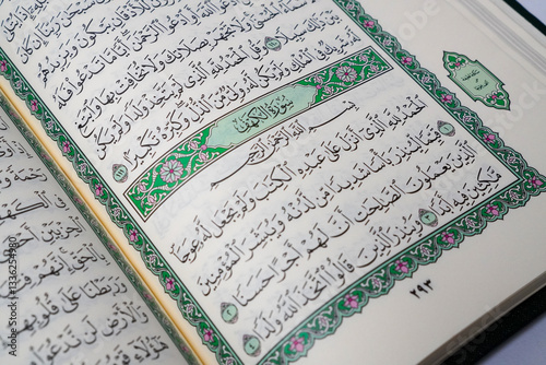An open Quran displaying Surah Al-Kahf, a chapter of wisdom and guidance, often recited on Fridays by Muslims worldwide