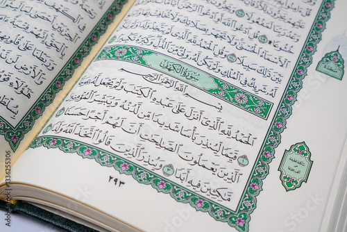 An open Quran displaying Surah Al-Kahf, a chapter of wisdom and guidance, often recited on Fridays by Muslims worldwide
