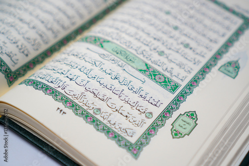 An open Quran displaying Surah Al-Kahf, a chapter of wisdom and guidance, often recited on Fridays by Muslims worldwide