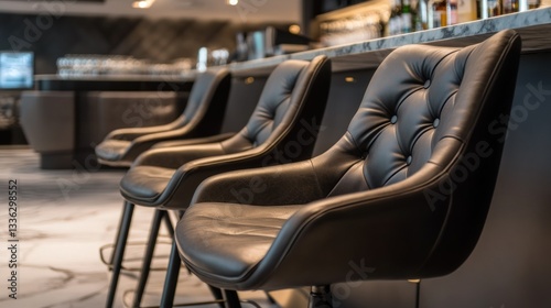 Several elegant leather bar chairs lined up at a countertop