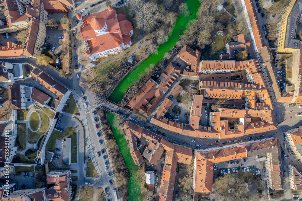 Fototapeta premium Aerial spring day view of emerald green Vilnelė river for irish St. Patrick's Day in Uzupis district, Vilnius, Lithuania