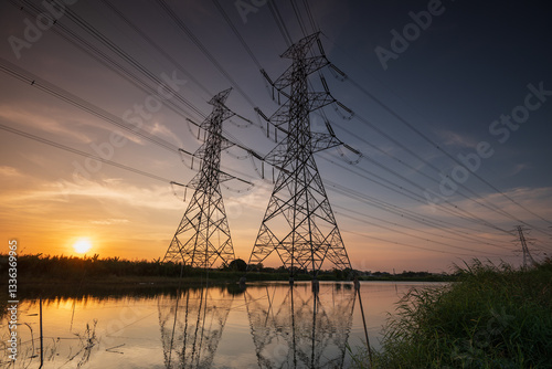 High voltage electrical pole structure or high voltage electric transmission tower at sunset