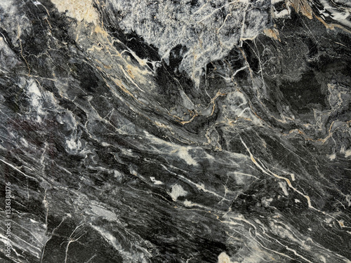 Natural black forest marble, or black and white marble slab pattern. Black honed marble with wavy white veins, rough stone texture. Seamless pattern.