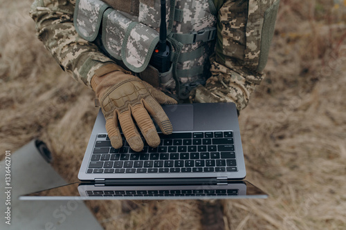 Soldier Using Laptop in Camouflage Uniform Amidst Nature