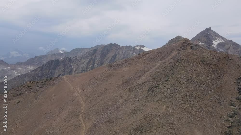 Hikers on a steep mountain ridge in the Caucasus region Hikers on a steep mountain ridge in the Caucasus region