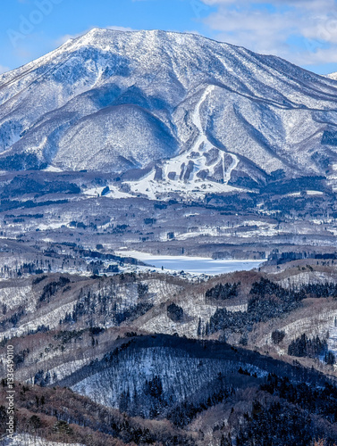 Obraz na płótnie Snow covered winter landscape with blue sky and background mountains w salonie