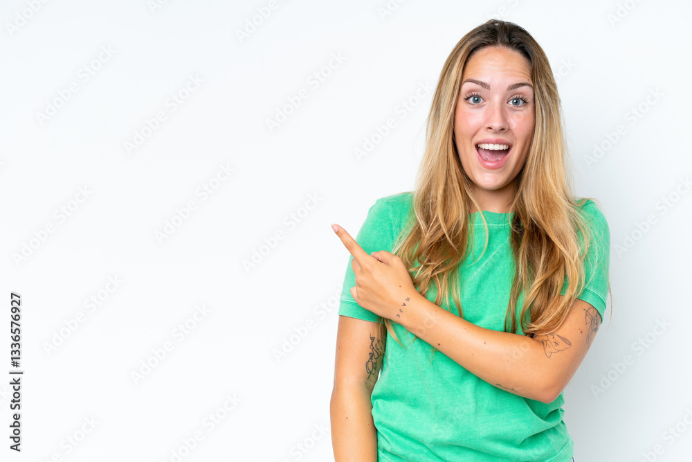 Young caucasian woman isolated on white background surprised and pointing side Young caucasian woman isolated on white background surprised and pointing side
