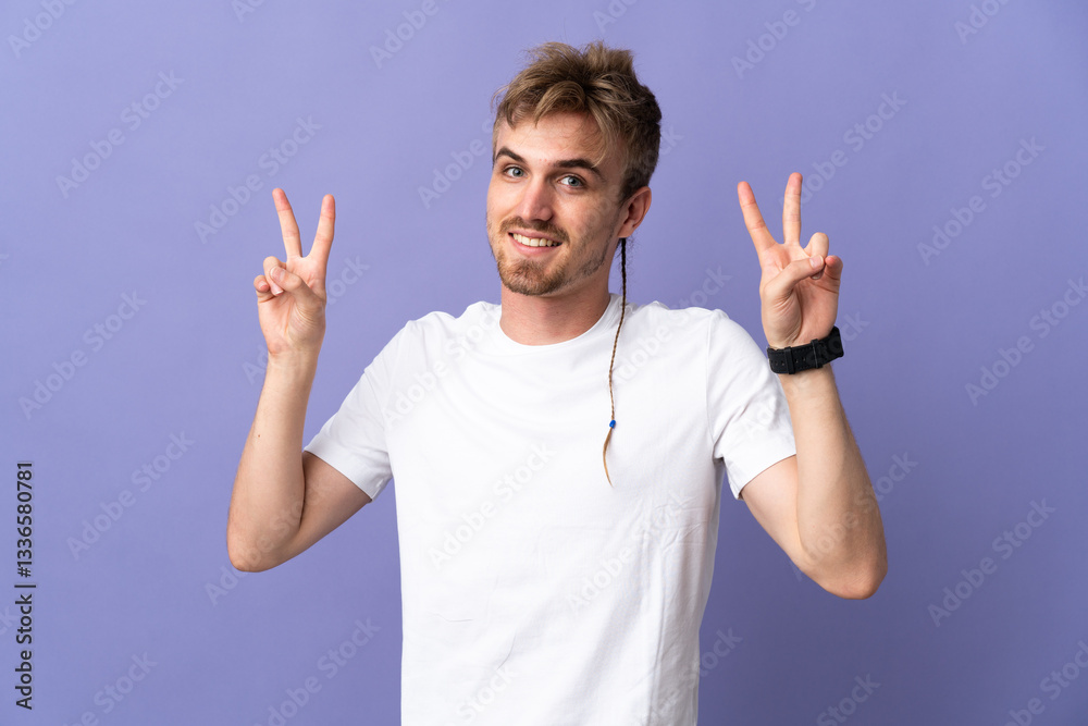 Young handsome blonde man isolated on purple background showing victory sign with both hands Young handsome blonde man isolated on purple background showing victory sign with both hands