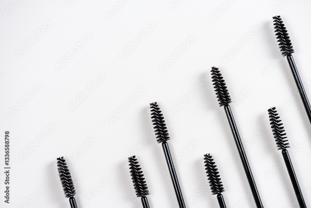 Group of black brushes for eyelash and eyebrow makeup. Women beauty and eye makeup. Group of black brushes for eyelash and eyebrow makeup. Women beauty and eye makeup.