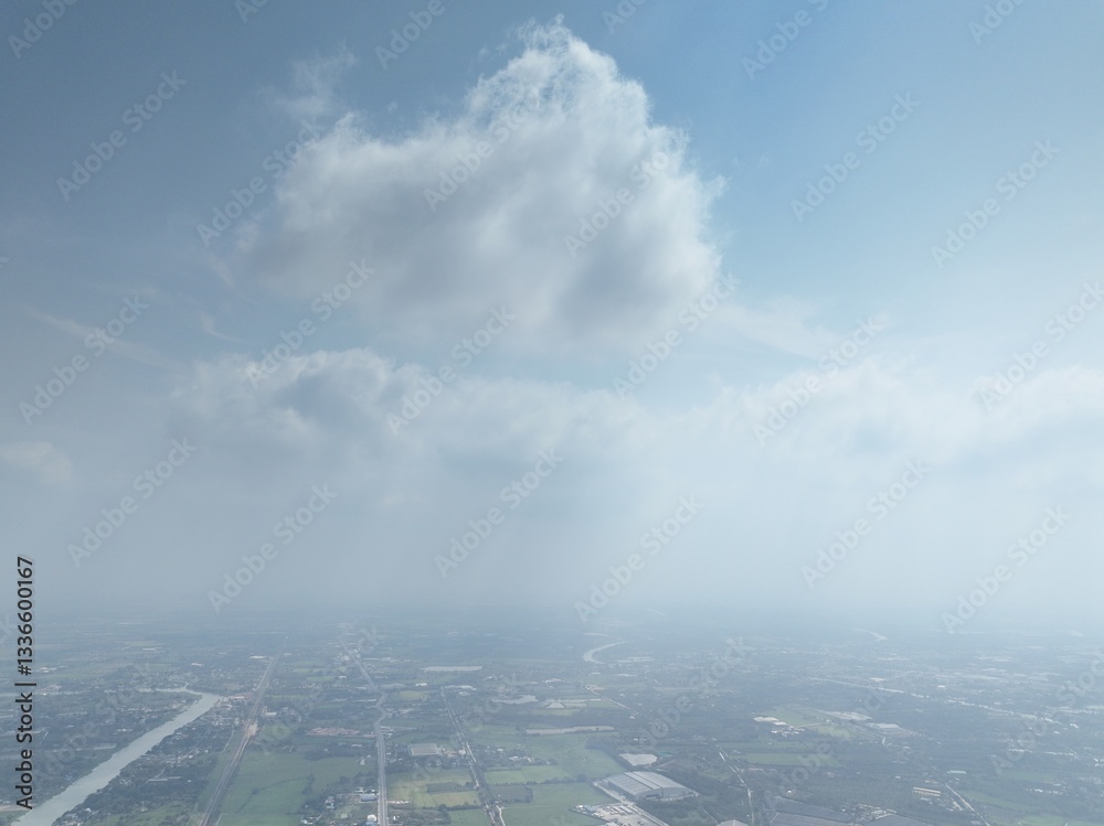 Fototapeta premium The River's Embrace: An Aerial Glimpse of little town Urban Heart. This drone photograph captures a wide aerial view of Nakhon Pathom, Thailand, with a focus on the river that flows through town