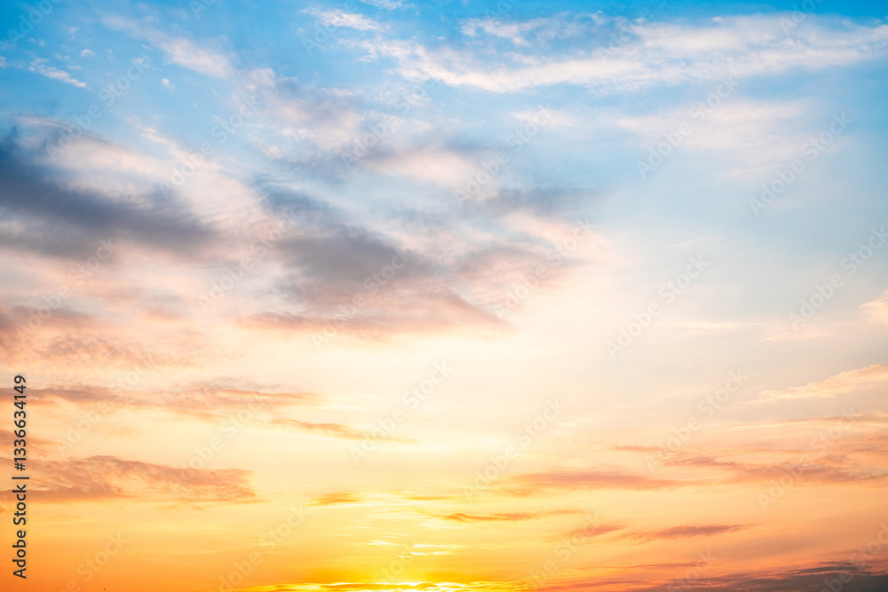 Obraz premium Sky,sunset, beautiful , luxury soft gradient orange gold clouds and sunlight on the blue sky perfect for the background, Sunrise on morning or everning in winter warm time ,Twilight summer,silhouette