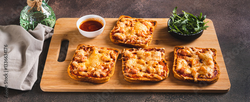 Obraz na płótnie Baked sandwiches with bacon, cheese and tomato sauce on a board on a table web banner w salonie