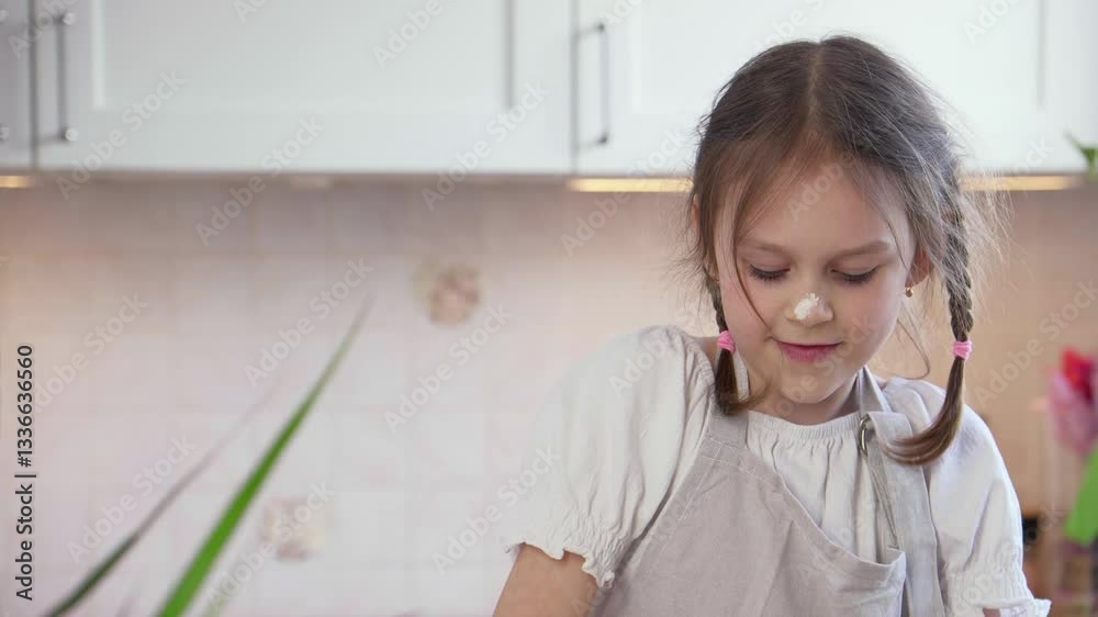 The girl improves her pizza cooking skills in a cozy kitchen. Prepares the dough The girl improves her pizza cooking skills in a cozy kitchen. Prepares the dough