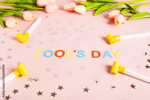Obraz na płótnie April Fools' Day written in colored letters, whistles, stars and tulips on pink w salonie