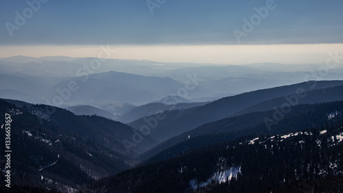 Backpackers hiking in Tatras mountains in snowy winter.