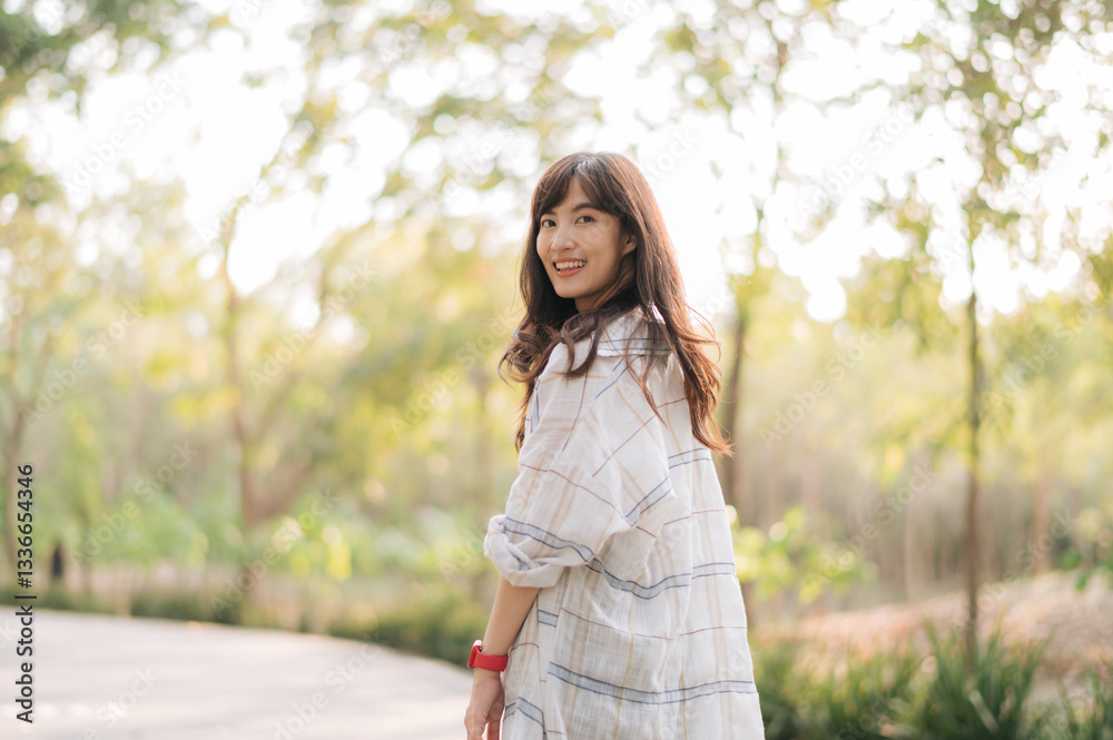 Asian woman enjoying summer outdoors, breathing fresh air with joyful smile, surrounded by greenery and sunlight Asian woman enjoying summer outdoors, breathing fresh air with joyful smile, surrounded by greenery and sunlight