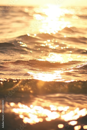 Golden Sunlit Ocean Waves at Sunset Creating Warm, Reflective Seascape.
