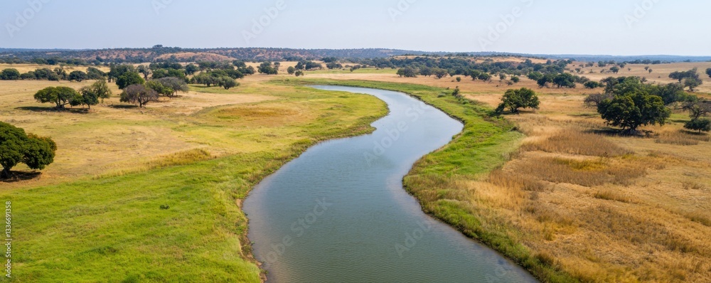 Serene river winding through a picturesque landscape with lush greenery and open fields. Serene river winding through a picturesque landscape with lush greenery and open fields.