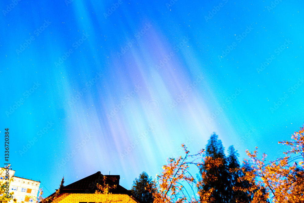 landscape with gorgeous northern lights over the roof of the house, brightly colored aurora
