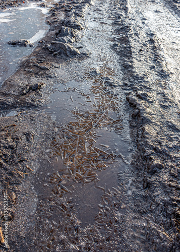 Obraz na płótnie abstract frozen ice texture on muddy swamp road w salonie