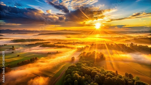 Golden hour aerial landscape: sunburst explodes over dusty lowlands, overexposed below.