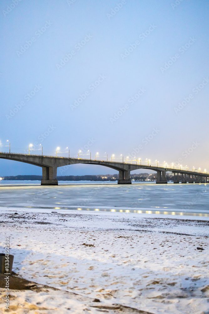bridge accross frozen river in Kostroma in evening bridge accross frozen river in Kostroma in evening