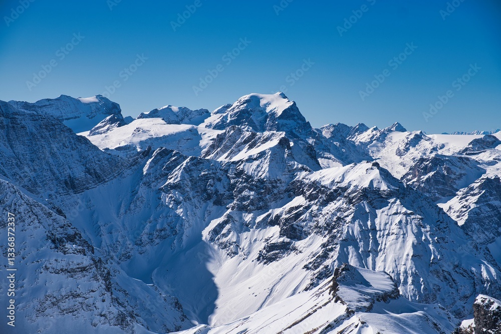 Obraz premium Big view in the Swiss Alps. Fantastic winter sports weather in the mountains of Glarus, Switzerland. Ski mountaineering surrounded by tall mountains. Skitour above Elm. Hausstock.