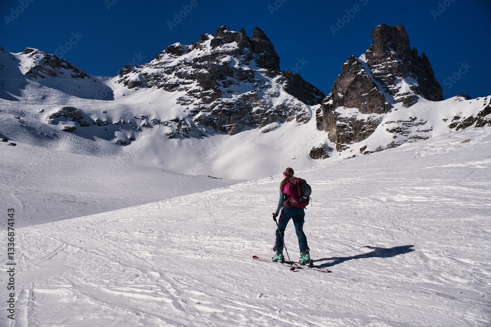 A mountaineer on her way up Mount Pizol. A winter ascent on skis to the ski depot, then a hike with crampons and ice axe to the summit. Ski mountaineering in Wintertime. young woman climbs the Pizol. A mountaineer on her way up Mount Pizol. A winter ascent on skis to the ski depot, then a hike with crampons and ice axe to the summit. Ski mountaineering in Wintertime. young woman climbs the Pizol.