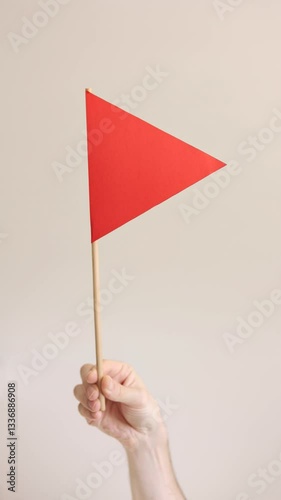 Red flag in the hands of a man. Vertical video. Choosing a partner for a relationship concept. Bad qualities of a boyfriend.