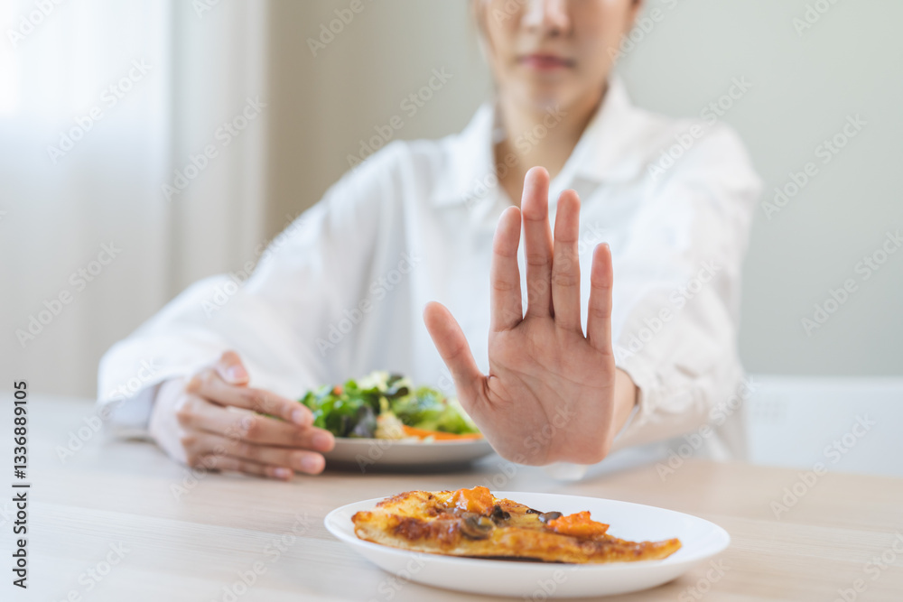 Diet concept, asian young woman close up hand push out away Pizza, refuse junk process, carb food on plate, choose green vegetable salad, eat low fat for good health. Female people getting weight loss Diet concept, asian young woman close up hand push out away Pizza, refuse junk process, carb food on plate, choose green vegetable salad, eat low fat for good health. Female people getting weight loss