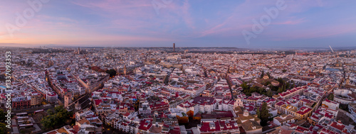 Aerial view of Seville historic town center Casco antiguo with churches, monuments, during sunrise