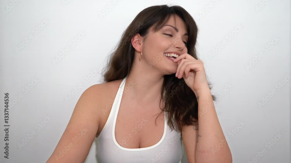 Happy Laughing Young Brunette Woman With Tattoo Posing On The White Background In The Studio Happy Laughing Young Brunette Woman With Tattoo Posing On The White Background In The Studio