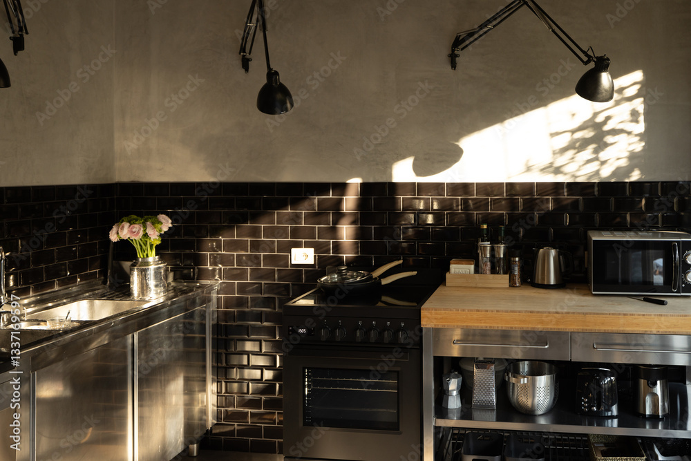 Stylish industrial kitchen with black subway tiles, stainless steel cabinets, and wooden countertops